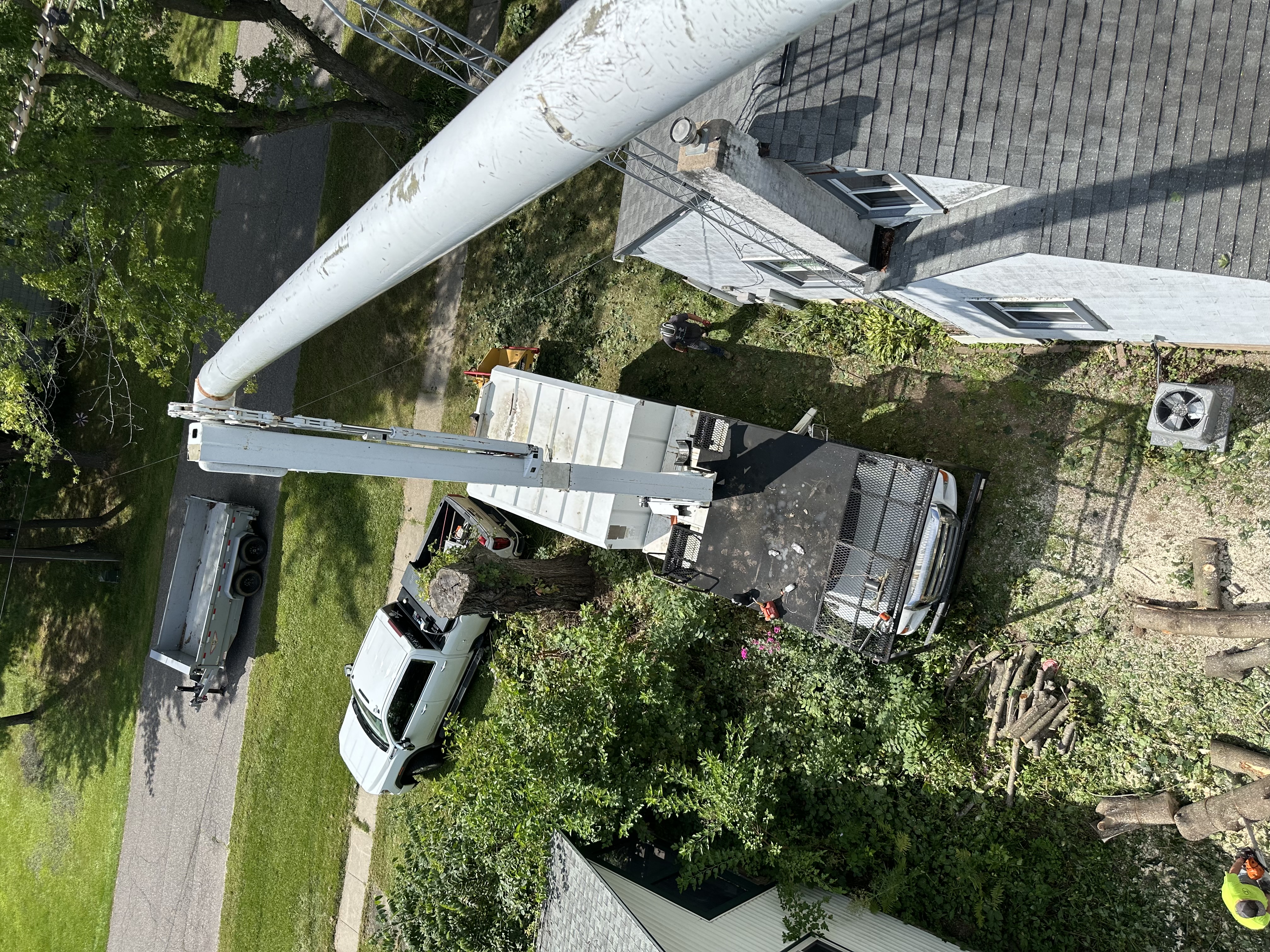 Bucket truck working next to a house